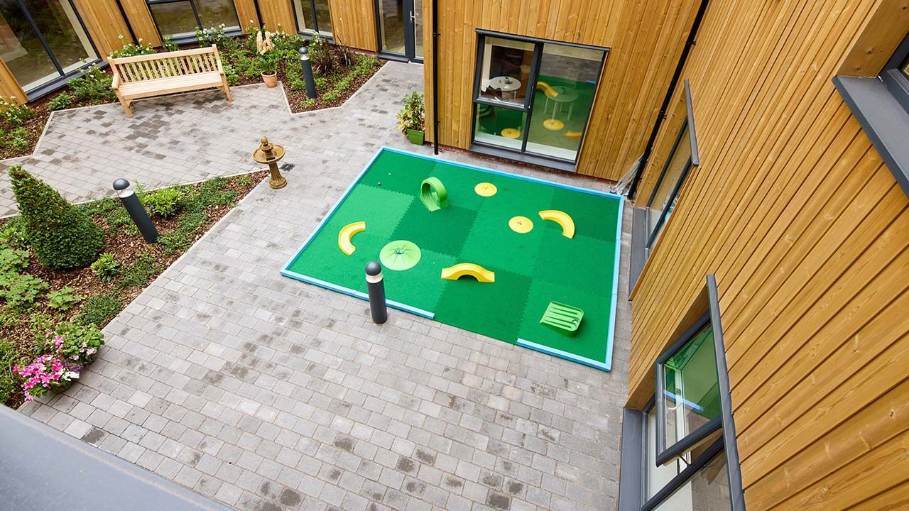 Outdoor activity area with plants and play equipment